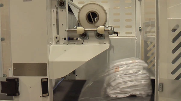 Video of laundry shrink wrapping process